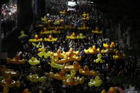 Protesters carry inflatable yellow ducks, which have become good-humored symbols of resistance during anti-government rallies, while marching towards the base of the 11th Infantry Regiment, a palace security unit under direct command of the Thai king, Sunday, Nov. 29, 2020 in Bangkok, Thailand. Pro-democracy demonstrators are continuing their protests calling for the government to step down and reforms to the constitution and the monarchy, despite legal charges being filed against them and the possibility of violence from their opponents or a military crackdown. (AP Photo/Sakchai Lalit)