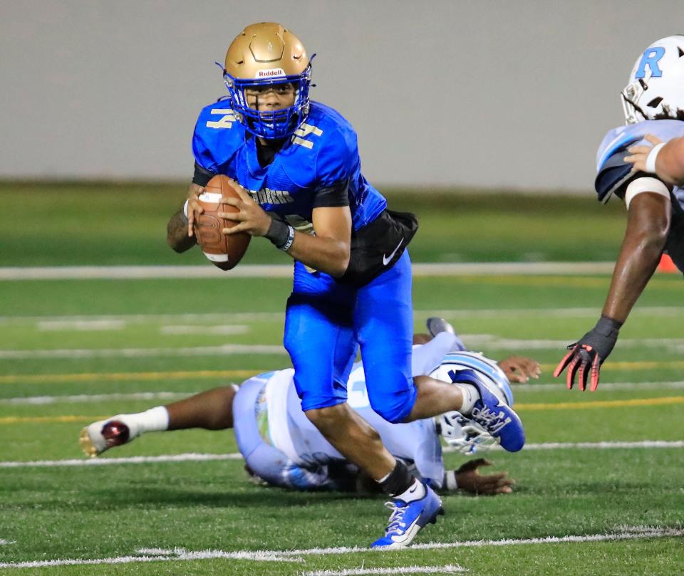 Mainland’s DJ Murray (14) looks downfield to throw during Friday night’s game against Rockledge, Nov. 17, 2023.