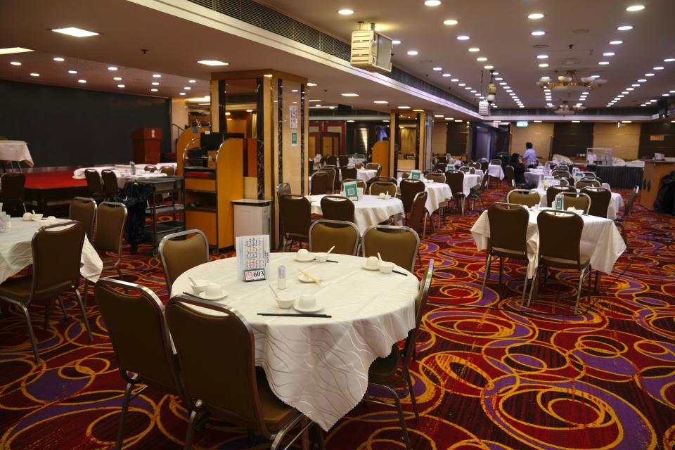 Empty table are seen in a Chinese restaurant in Hong Kong, Friday, Jan. 14, 2022. Hong Kong International Airport said Friday that it would ban passengers from over 150 countries and territories from transiting in the city for a month, as it sought to stem the transmission of the highly contagious omicron variant of the coronavirus. (AP Photo/Kin Cheung)