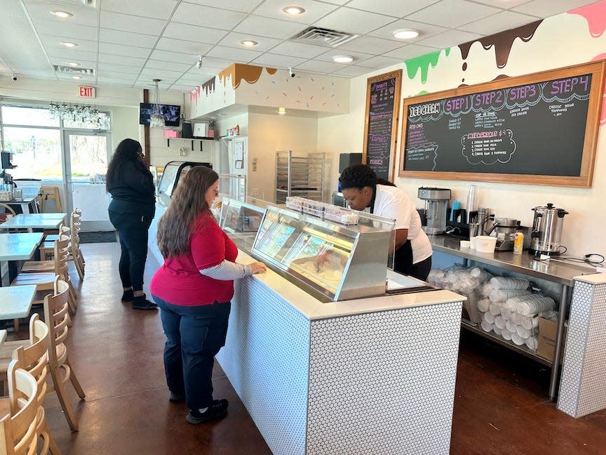 Cameo Williams, right, serves up a milkshake on Wednesday at Totes Ice Cream, 1714 SE Hawthorne Road, in Gainesville.