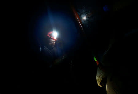 FILE PHOTO: Mine workers employed at Sibanye Gold's Masimthembe shaft operate a drill in Westonaria, South Africa, April 3, 2017. REUTERS/Mike Hutchings/File Photo