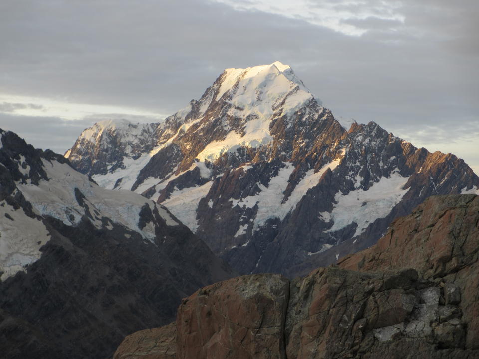 FILE - This March 30, 2014, photo shows Mt. Cook, New Zealand's highest mountain, at sunset in Twizel, New Zealand. New Zealand lawmakers have joined together across the aisle to pass a bill aimed at combating climate change. The Zero Carbon bill aims to make New Zealand reduce its greenhouse gas emissions to the point the country becomes mostly carbon neutral by 2050. (AP Photo/Carey J. Williams, File)