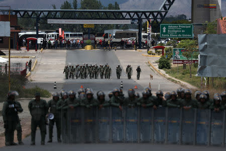 Venezuelan national guard members stand guard, at the border, seen from in Pacaraima, Brazil February 24, 2019. REUTERS/Ricardo Moraes