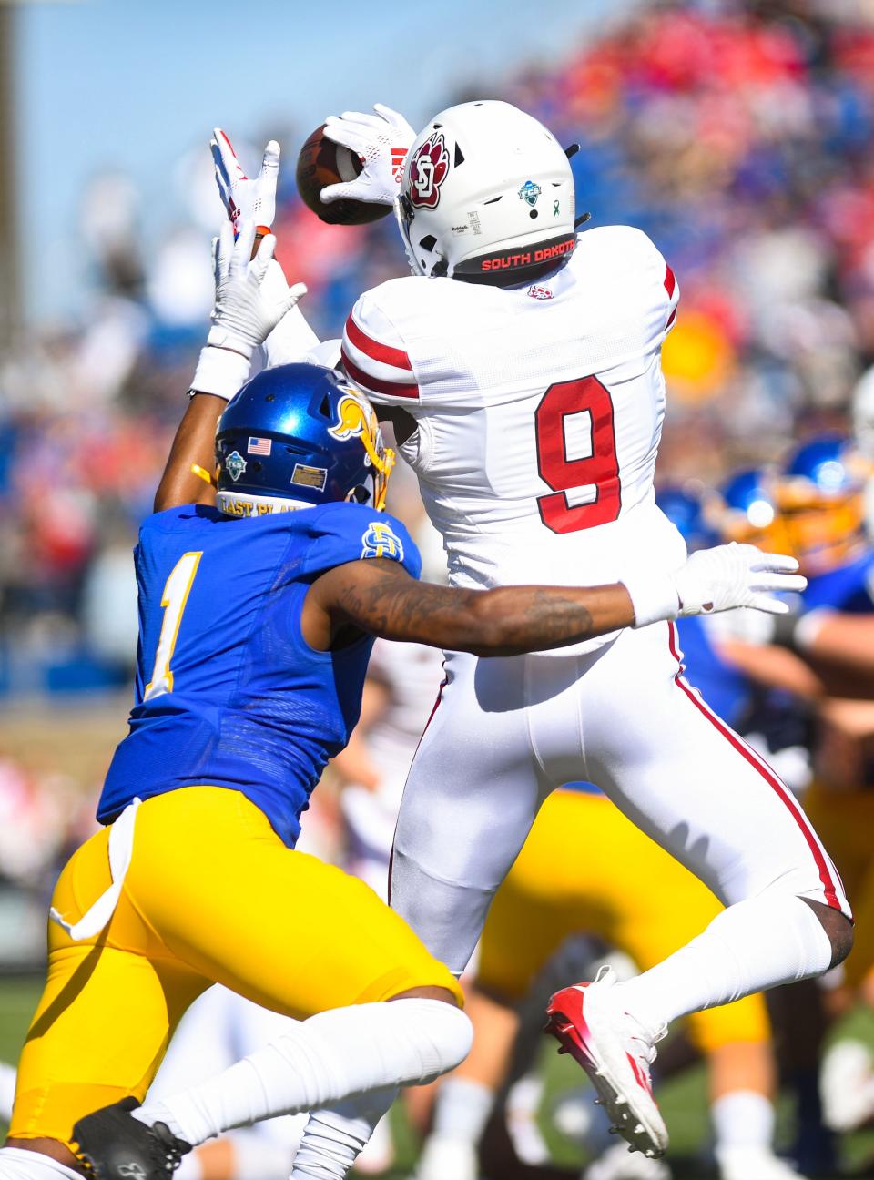 South Dakota’s Wesley Eliodor jumps to make a catch while closely guarded by South Dakota State’s Malik Lofton in a football game on Saturday, October 8, 2022, at Dana J. Dykhouse Stadium in Brookings.