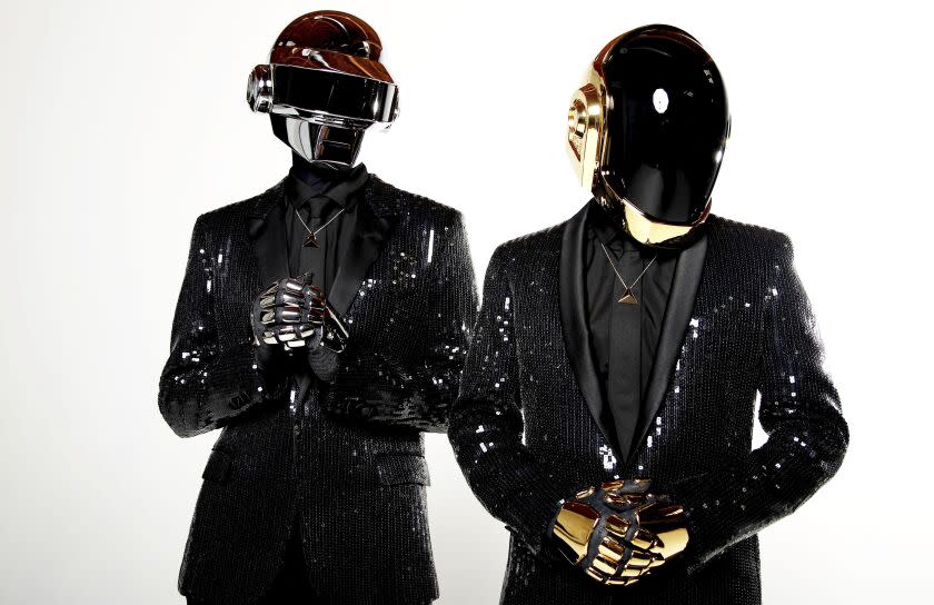 Thomas Bangalter, left, and Guy-Manuel de Homem-Christo of Daft Punk, dressed in robot costumes and chiny suits