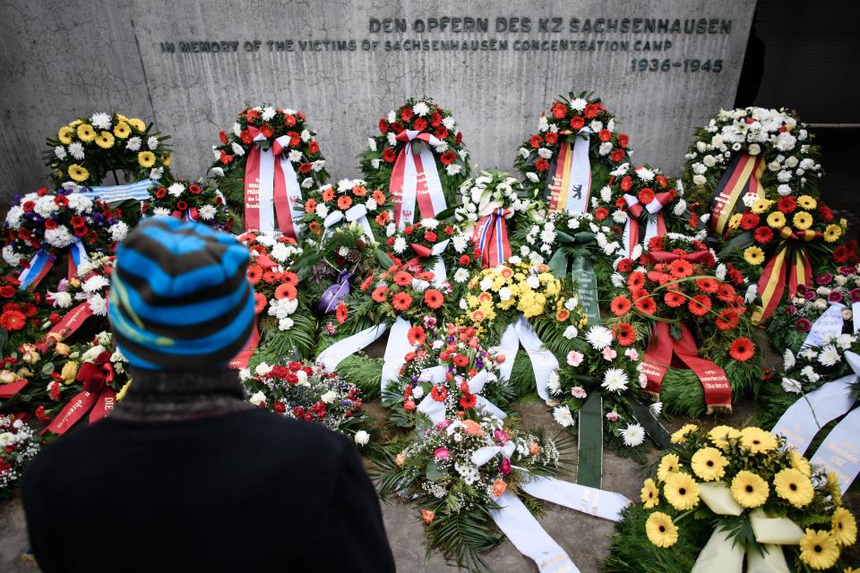 <p><br>A guest stands in front of wreaths during a remembrance ceremony at the former concentration camp Sachsenhausen in Oranienburg near Berlin, Germany, Jan. 27, 2018. Today world commemorates The International Holocaust Remembrance Day. (Photo: Clemens Bilan/EPA-EFE/REX/Shutterstock) </p>