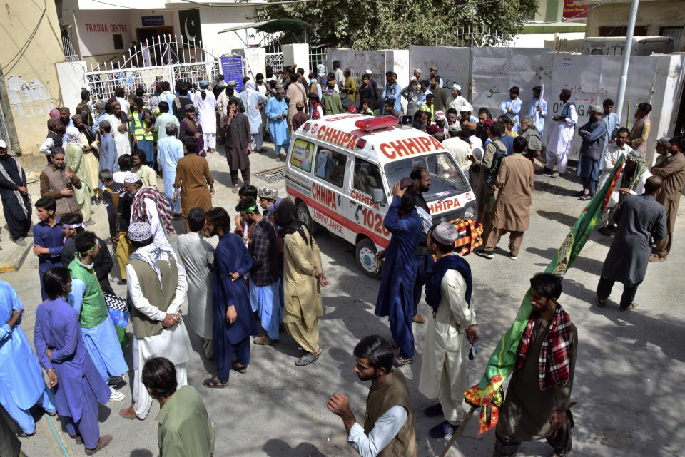People gather at a hospital, where injured victims of a bomb explosion are brought, in Quetta, Pakistan, Friday, Sept. 29, 2023. A powerful bomb exploded at a rally celebrating the birthday of Islam's Prophet Muhammad in southwest Pakistan on Friday, killing multiple people and wounding dozens of others, police and a government official said. (AP Photo/Arshad Butt)