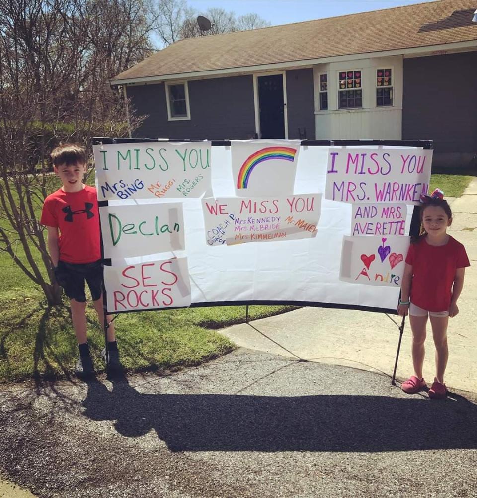 Declan and Andie Michaelis hold up a sign of love for their teachers. / Courtesy Jessica Michaelis.