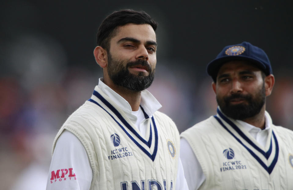 India's Mohammed Shami, right, watches as captain Virat Kohli gestures jokingly as they leave the field at the end of play on the third day of the World Test Championship final cricket match between New Zealand and India, at the Rose Bowl in Southampton, England, Sunday, June 20, 2021. (AP Photo/Ian Walton)