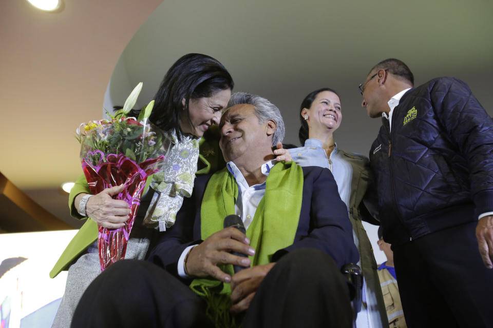Alianza PAIS's presidential candidate Lenin Moreno and his wife Rocio Gonzalez, and Cinthia Díaz and her husband vice presidential candidate Jorge Glas, back, share a moment at the end of election day, in Quito, Ecuador, Sunday, April 2, 2017. (AP Photo/Dolores Ochoa)