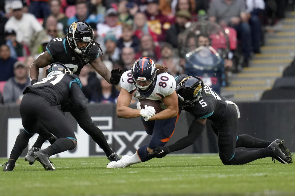 Denver Broncos tight end Greg Dulcich (80) holds the ball during the NFL football game between Denver Broncos and Jacksonville Jaguars at Wembley Stadium London, Sunday, Oct. 30, 2022. (AP Photo/Kirsty Wigglesworth)