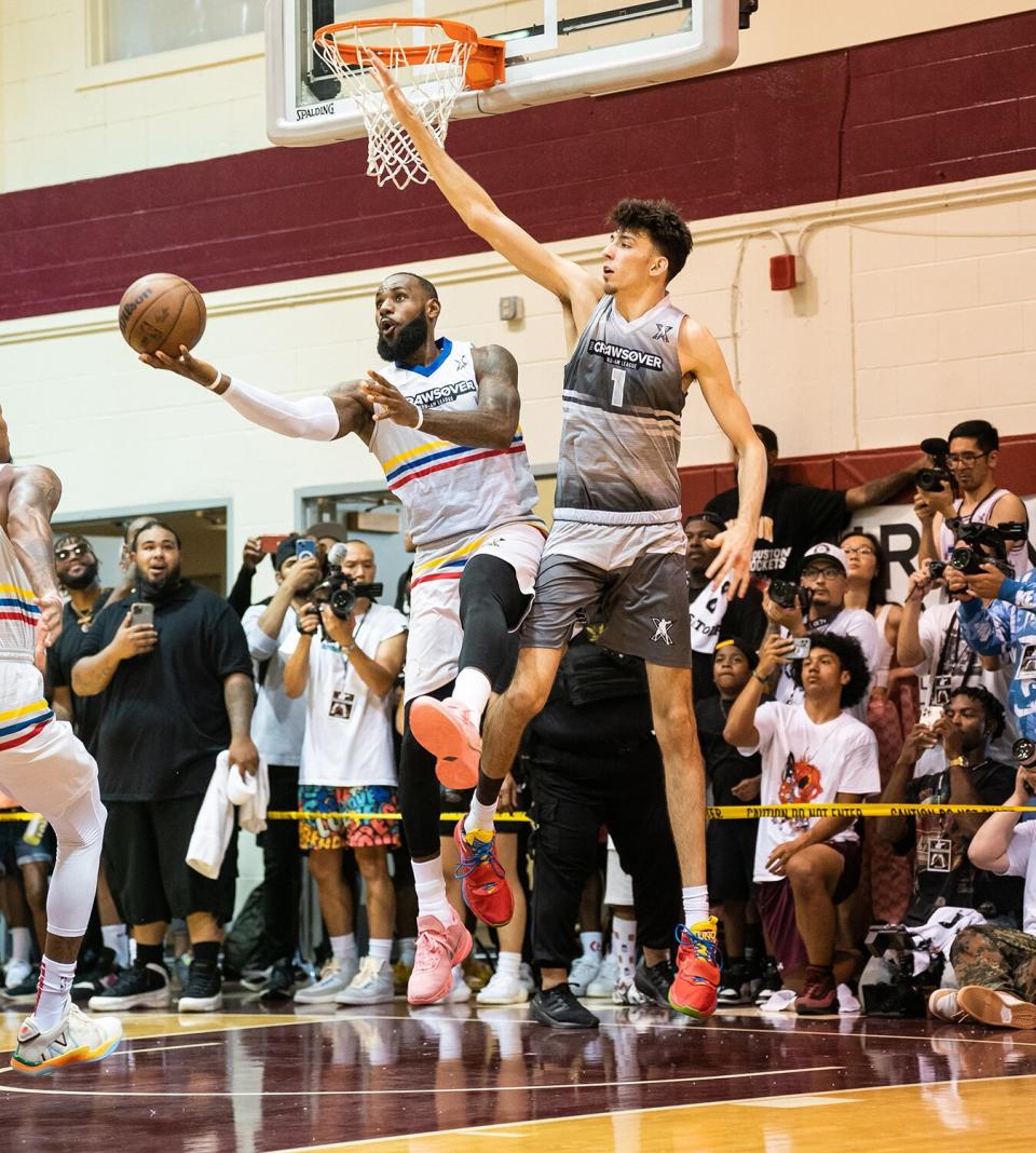 LeBron James shoots the ball over Chet Holmgren during the CrawsOver Pro-Am game at Seattle Pacific University on August 20, 2022 in Seattle, Washington.