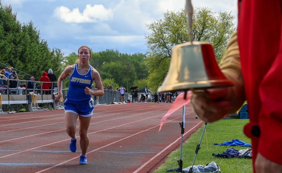 With one lap to go in the 1,600 meters, the bell rings for Jefferson's Jenna Pilachowski at the 59th annual Mason Invitational on Saturday, May 11, 2024.