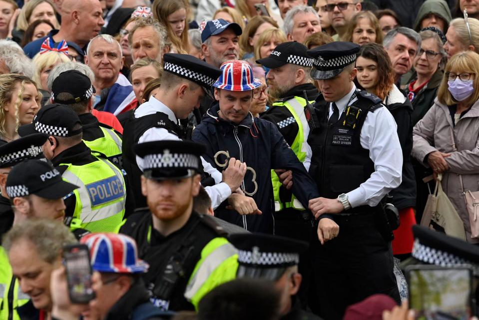 Protesters from climate protest group 'Just Stop Oil' are apprehended by police officers in the crowd close to where Britain's King Charles III and Britain's Camilla, Queen Consort will be crowned at Westminster Abbey in central London on May 6, 2023. - The set-piece coronation is the first in Britain in 70 years, and only the second in history to be televised. Charles will be the 40th reigning monarch to be crowned at the central London church since King William I in 1066. (Photo by JUSTIN TALLIS / POOL / AFP) (Photo by JUSTIN TALLIS/POOL/AFP via Getty Images)