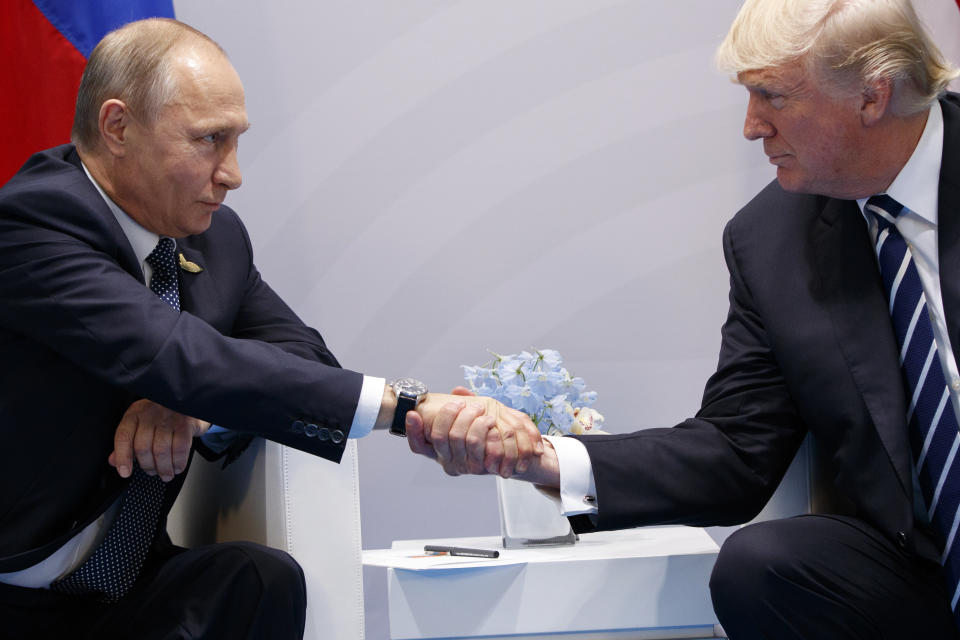 FILE - In this July 7, 2017, file photo, President Donald Trump shakes hands with Russian President Vladimir Putin at the G20 Summit in Hamburg. Trump has strenuously sought to keep an entente cordiale, an informal alliance of sorts, with Putin. This in the face of his own intelligence agencies' confirmation of Moscow's interference in the 2016 election, which sought to aid him, and Moscow secretly offering bounties to the Taliban for the deaths of Americans in Afghanistan. (AP Photo/Evan Vucci, File)