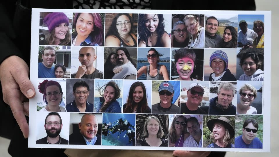 A photo collage of the 34 people who died aboard the Conception is held by a victim's family member. - Damian Dovarganes/AP