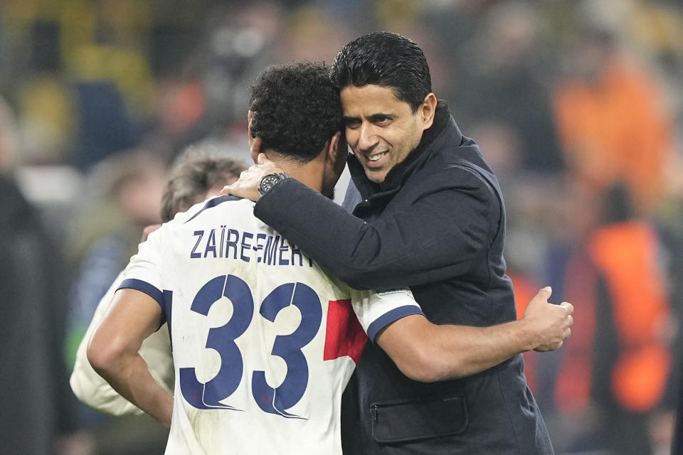 PSG president Nasser Al-Khelaifi, right, and PSG's Warren Zaire-Emery hug after the Champions League Group F soccer match between Borussia Dortmund and Paris Saint-Germain at the Signal Iduna Park in Dortmund, Germany, Wednesday, Dec. 13, 2023. (AP Photo/Martin Meissner)