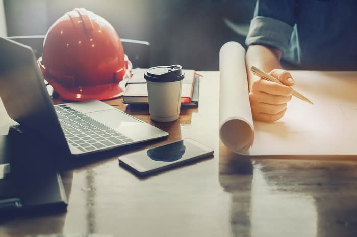 An architect drawing plans on his desk