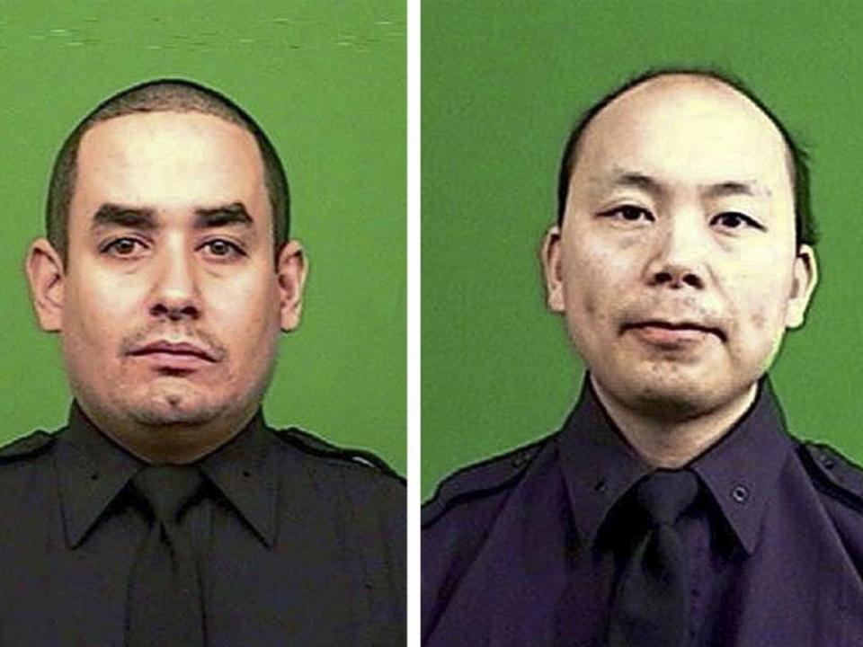 Rafael Ramos and Wenjian Liu, right, were shot dead while sitting in their patrol car in Brooklyn (EPA)