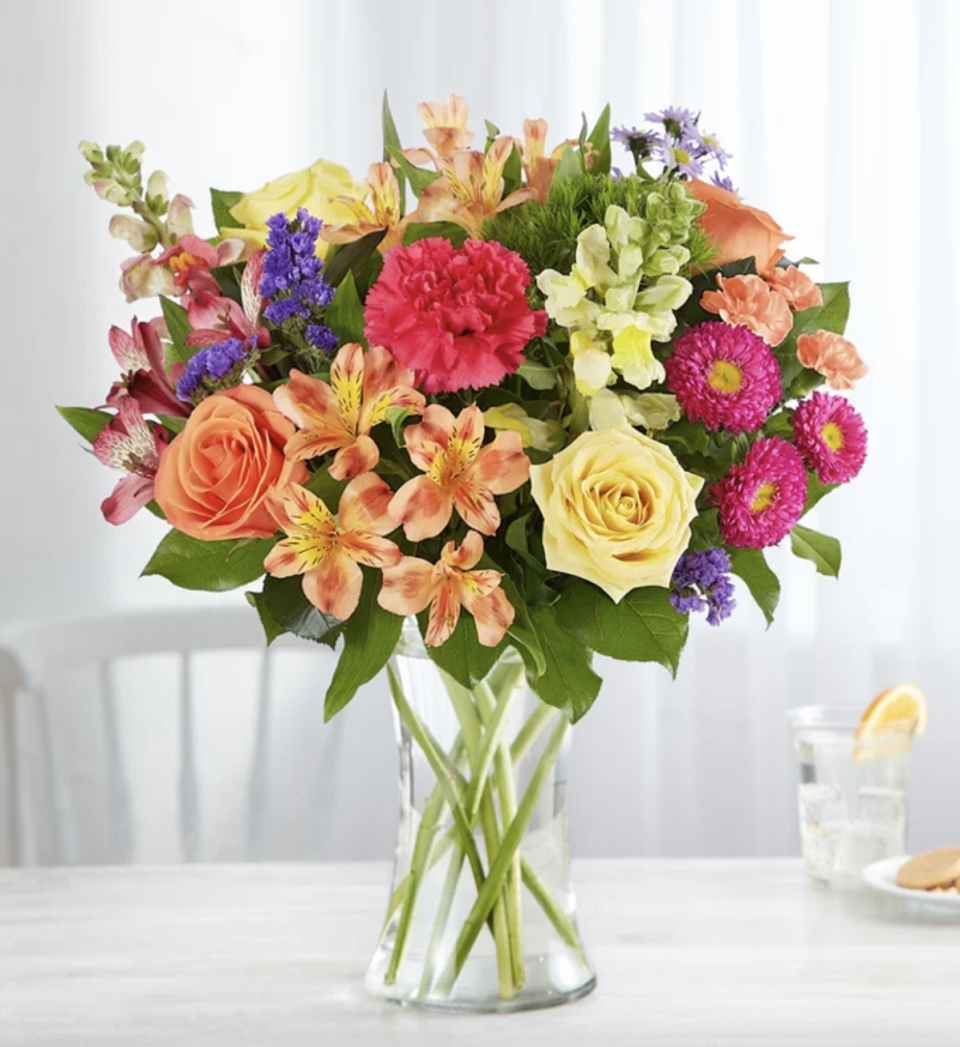 Vibrant Floral Medley with yellow, orange, green flowers (Photo via 1-800-Flowers)