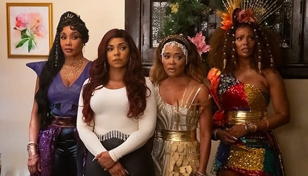 Ashanti stands surrounded by the Christmas spirits in a still from A New Diva's Christmas Carol