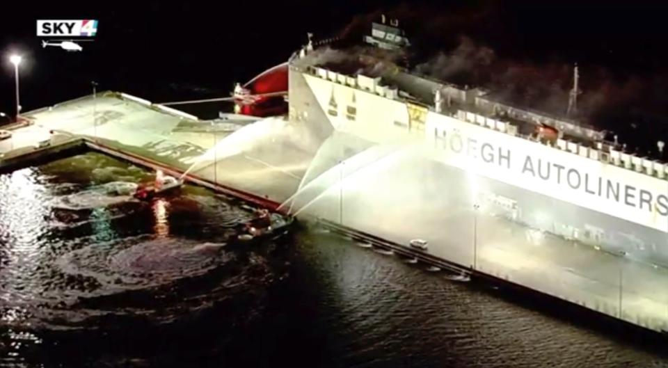 In this image made from aerial video taken on June 4, 2020, firefighters spray a cargo ship with water, in Jacksonville, Florida.