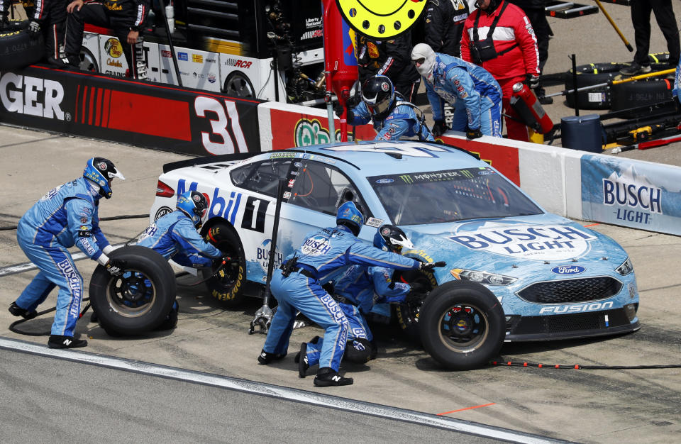 Kevin Harvick's crew works during a pitstop during a NASCAR Cup Series auto race at Michigan International Speedway in Brooklyn, Mich., Sunday, Aug. 12, 2018. (AP Photo/Paul Sancya)