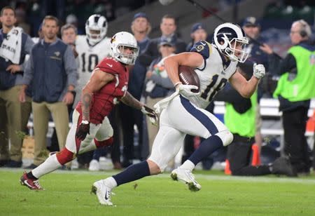 Oct 22, 2017; London, United Kingdom; Los Angeles Rams wide receiver Cooper Kupp (18) runs after a catch and scores on an 18 yard touchdown reception in the fourth quarter against the Arizona Cardinals during an NFL International Series game at Twickenham Stadium. The Rams defeated the Cardinals 33-0. Mandatory Credit: Kirby Lee-USA TODAY Sports