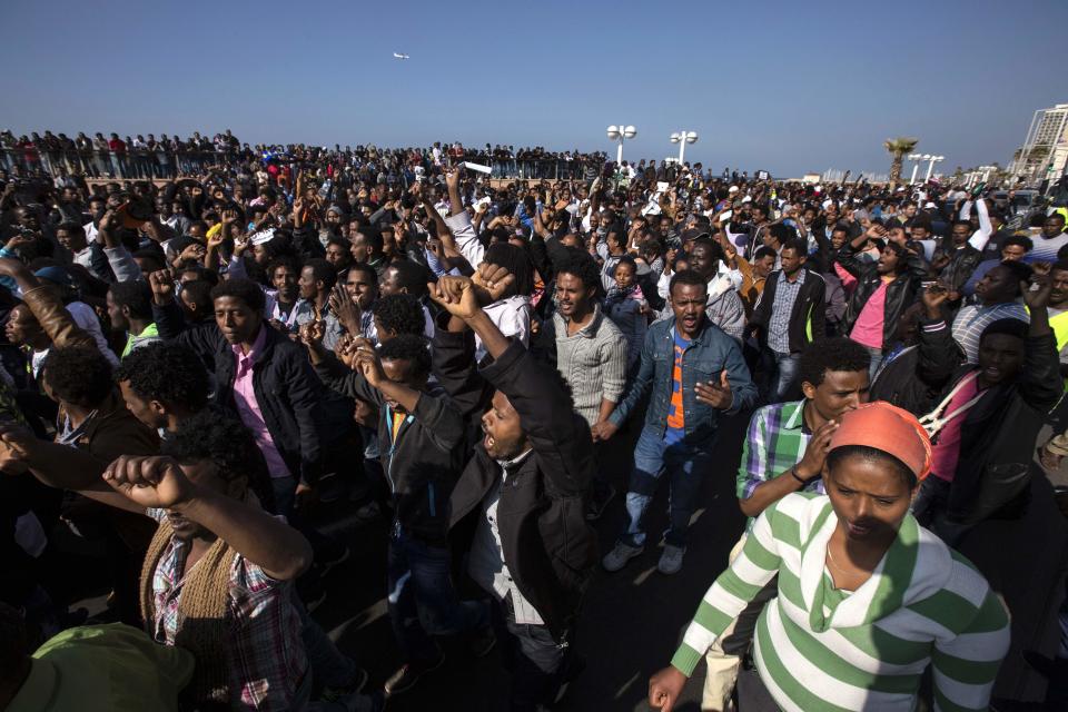 African migrants gesture during a protest outside the U.S. embassy in Tel Aviv