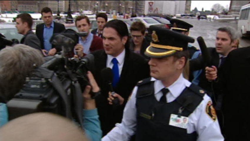 Senator Patrick Brazeau leaves the Senate after a vote to place him on a forced leave of absence, but he will continue to collect his pay