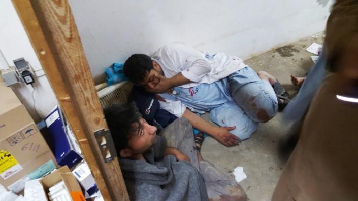 In this photograph released by Medecins Sans Frontieres (MSF) on October 3, 2015, Afghan MSF staff react in one of the remaining parts of the MSF hospital in Kunduz after it was hit by an air strike (AFP Photo/)