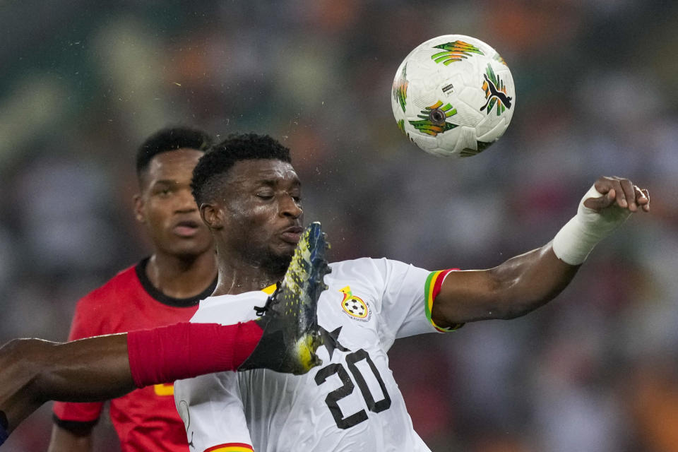Ghana's Mohammed Kudus, right, duels for the ball with Mozambique's Nanana during the African Cup of Nations Group B soccer match between Mozambique and Ghana in Abidjan, Ivory Coast, Monday, Jan.22, 2024. (AP Photo/Sunday Alamba)