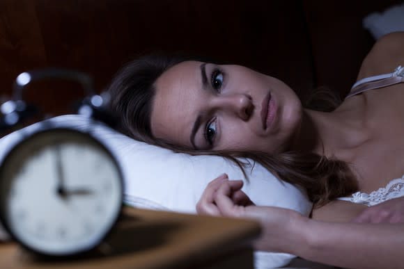 Woman lying awake in bed