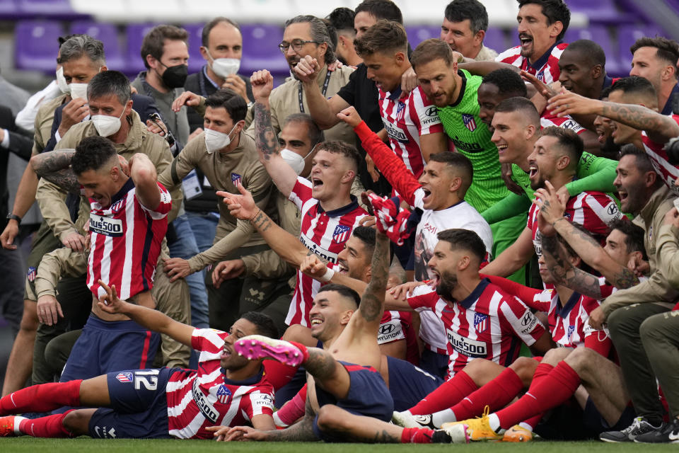 Atletico Madrid players celebrate at the end of the Spanish La Liga soccer match between Atletico Madrid and Valladolid at the Jose Zorrilla stadium in Valladolid, Spain, Saturday, May 22, 2021. Atletico won 2-1 and clinches its 11th Spanish La Liga title. (AP Photo/Manu Fernandez)