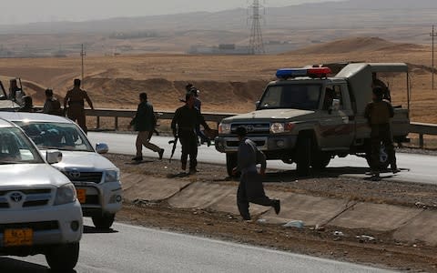 Kurdish security forces withdraw from a checkpoint in Alton Kupri, on the outskirts of Irbil, Iraq, Friday Oct. 20 - Credit: AFP