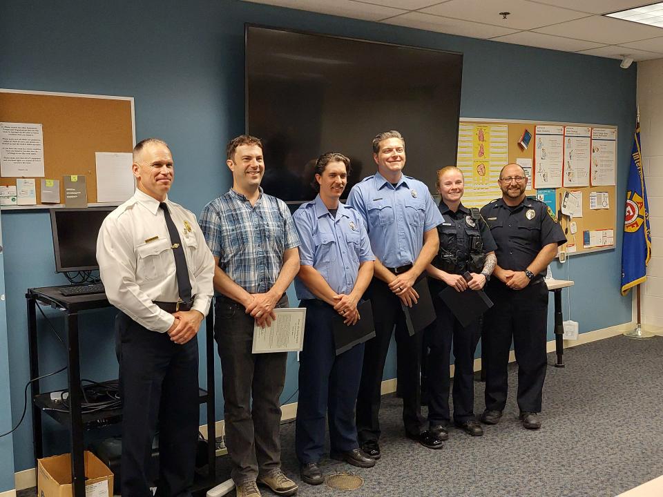 Left to Right: Fire Chief Bill Myers, kayaker Darren Bade, firefighters Tyler Simpkins and Matthew Bright, police officer Samantha McNulty, and Police Chief Nicholas Shearer pose for a photo after being recognized for their heroic efforts in saving a two-year-old