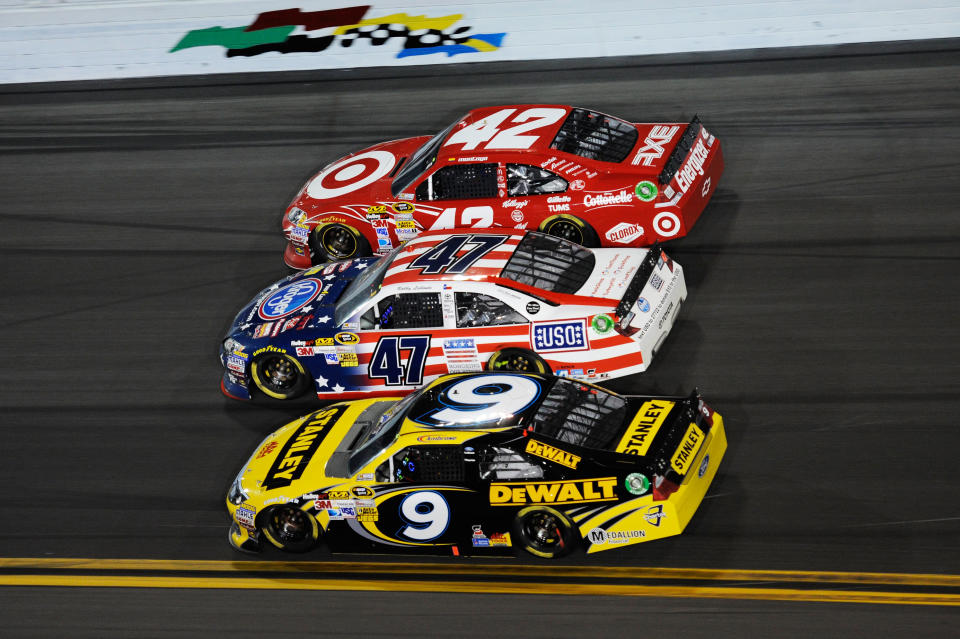 DAYTONA BEACH, FL - FEBRUARY 27: Juan Pablo Montoya, driver of the #42 Target Chevrolet, Bobby Labonte, driver of the #47 Kroger Toyota, and Marcos Ambrose, driver of the #9 Stanley Ford, race three wide during the NASCAR Sprint Cup Series Daytona 500 at Daytona International Speedway on February 27, 2012 in Daytona Beach, Florida. (Photo by John Harrelson/Getty Images for NASCAR)