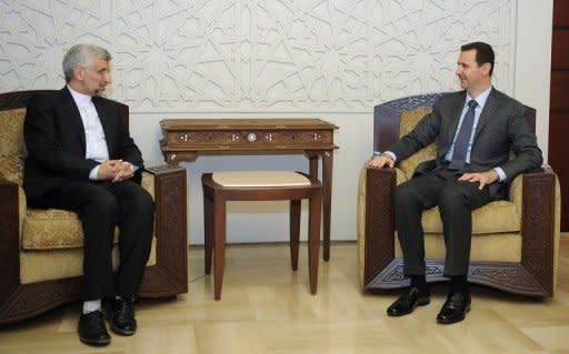A handout picture released by the official Syrian Arab News Agency shows Syrian President Bashar al-Assad (R) meeting with Saeed Jalili, a top aide to Iran's supreme leader Ayatollah Ali Khamenei, in Damascus on August 7
