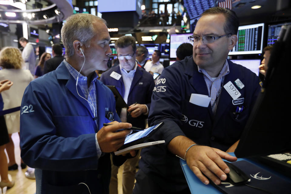 Trader Timothy Nick, left, and specialist Anthony Matesic work on the floor of the New York Stock Exchange, Friday, July 19, 2019. U.S. stocks moved broadly higher in early trading on Wall Street Friday and chipped away at the week's losses. (AP Photo/Richard Drew)