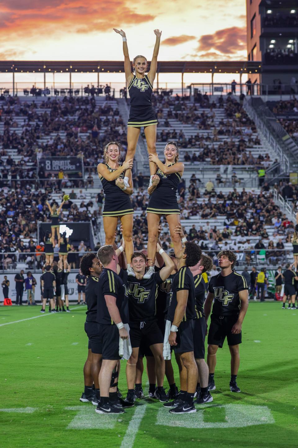 Sep 28, 2024; Orlando, Florida, USA; UCF Knights cheer team perform during the second half against the Colorado Buffaloes at FBC Mortgage Stadium. Mandatory Credit: Mike Watters-Imagn Images