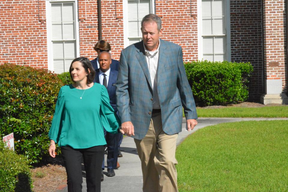 Former Palmetto State Bank CEO Russell Laffitte, at right, walks into the H.C. Courthouse on Friday with his wife, Susie, followed by attorneys and family members.