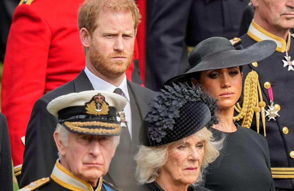 Britain's King Charles III, from bottom left, Camilla, the Queen Consort, Prince Harry and Meghan, Duchess of Sussex watch as the coffin of Queen Elizabeth II is placed into the hearse following the state funeral service in Westminster Abbey in central London Monday Sept. 19, 2022.