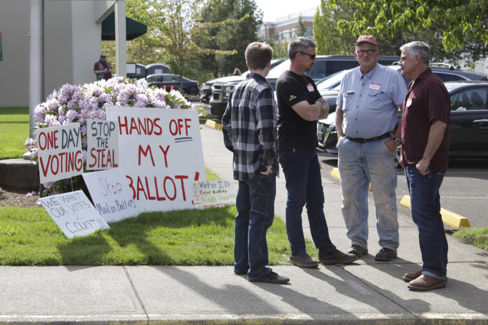 Protestors gather outside the Clackamas County, Oregon elections offices Oregon City, Oregon, on Wednesday, May 25, 2022. Voters in an Oregon county where a ballot-printing error has delayed election results for nearly two weeks have elected the same county clerk five times in the past 20 year despite missteps that impact two previous elections and cost taxpayers $100,000. Opponents have repeatedly tried to unseat Clackamas County Clerk Sherry Hall, who was first elected in 2002, following elections errors in 2004, 2010, and 2011 and a state vote-tampering investigation in 2012.(AP Photo/Gillian Flaccus)