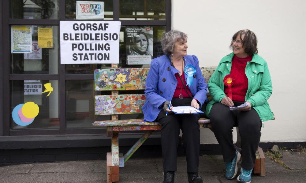 Two women sit outside a polling station in Rhiwbina, Wales