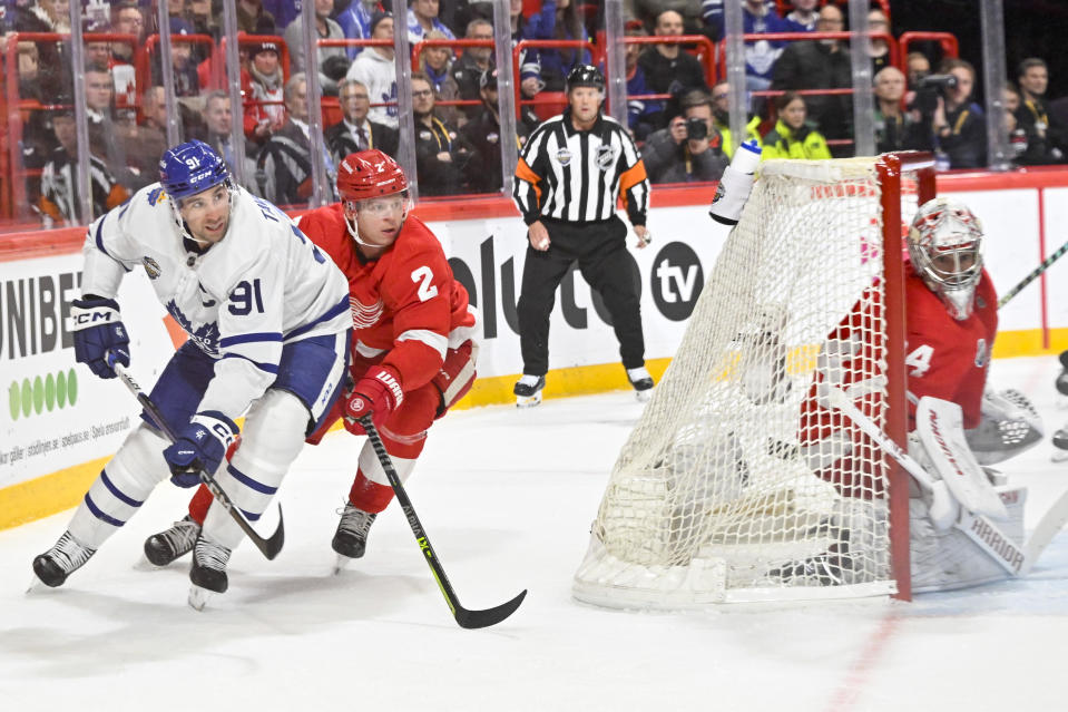 Toronto's John Tavares, left, and Detroit's Olli Maatta in action behind Detroit goalkeeper Alex Lyon during the NHL Global Series Sweden ice hockey match between Toronto Maple Leafs and Detroit Red Wings and at Avicii Arena in Stockholm, Sweden, Friday Nov. 17, 2023. (Henrik Montgomery/TT News Agency via AP)