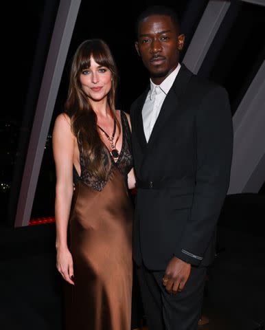 <p>Gilbert Flores/WWD via Getty</p> Dakota Johnson and Damson Idris