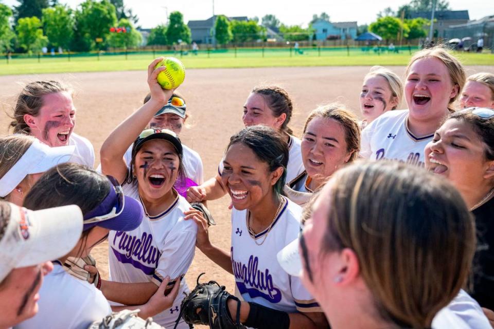 Puyallup players celebrate after beating Emerald Ridge, 8-5, to win the 4A West Central/Southwest district softball championship game at Kent Service Fields on Saturday, May 20, 2023, in Kent, Wash.