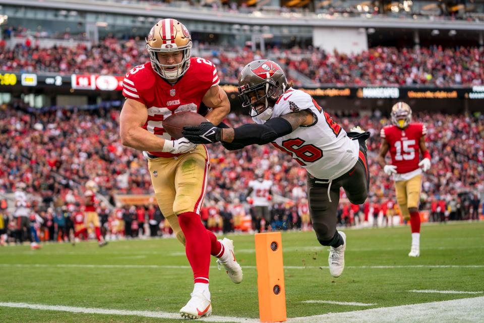 San Francisco 49ers running back Christian McCaffrey (23) scores a touchdown against Tampa Bay Buccaneers safety Logan Ryan (26) during the second quarter at Levi's Stadium.