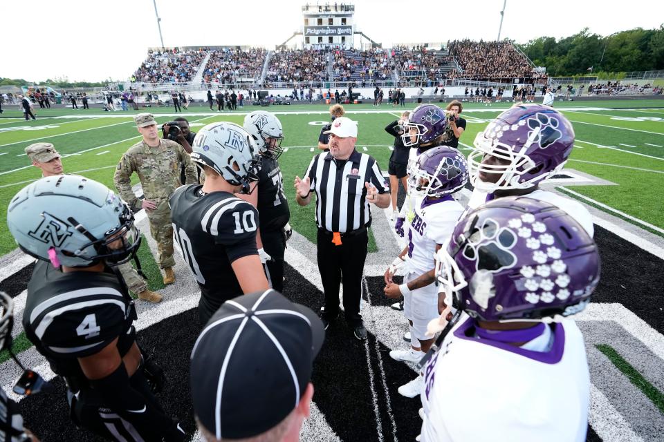 A referee speaks to captains of host Pickerington North and Pickerington Central before their game Sept. 8. The OHSAA has been working to replenish its officiating ranks, including trying to bring in high school students.