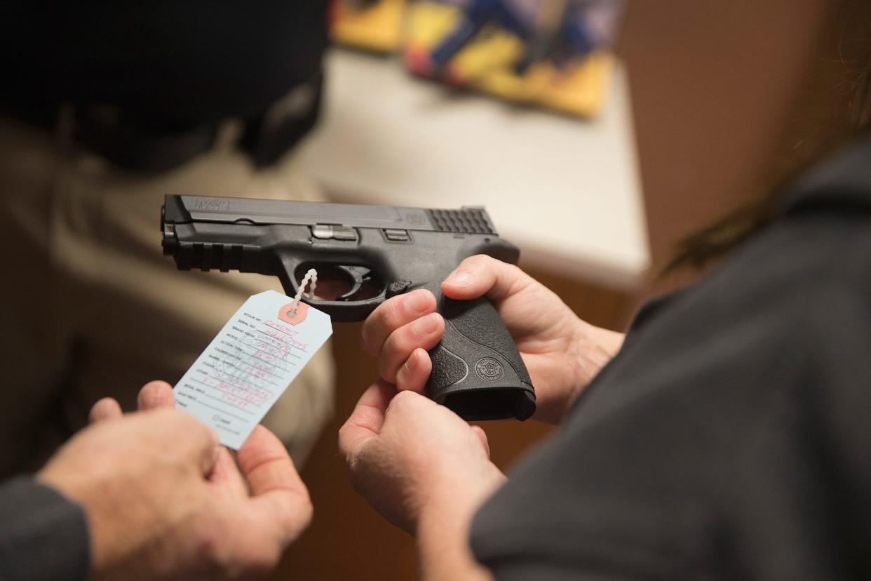 In this file photo, customers shop for a handgun at Metro Shooting Supplies on November 12, 2014, in Bridgeton, Missouri. A Michigan Court of Claims judge ruled Thursday, Nov. 16, 2023, that the Michigan House of Representatives violated the Open Meetings Act when it held committee hearings on the legislation which eventually created new gun safety laws.